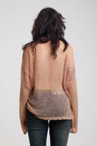 Back view of sheer dusty pink oversized open knit jumper, worn by model