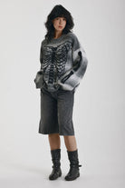 Grey spacedye stripe oversized knit jumper with skeleton ribcage graphic, worn by model