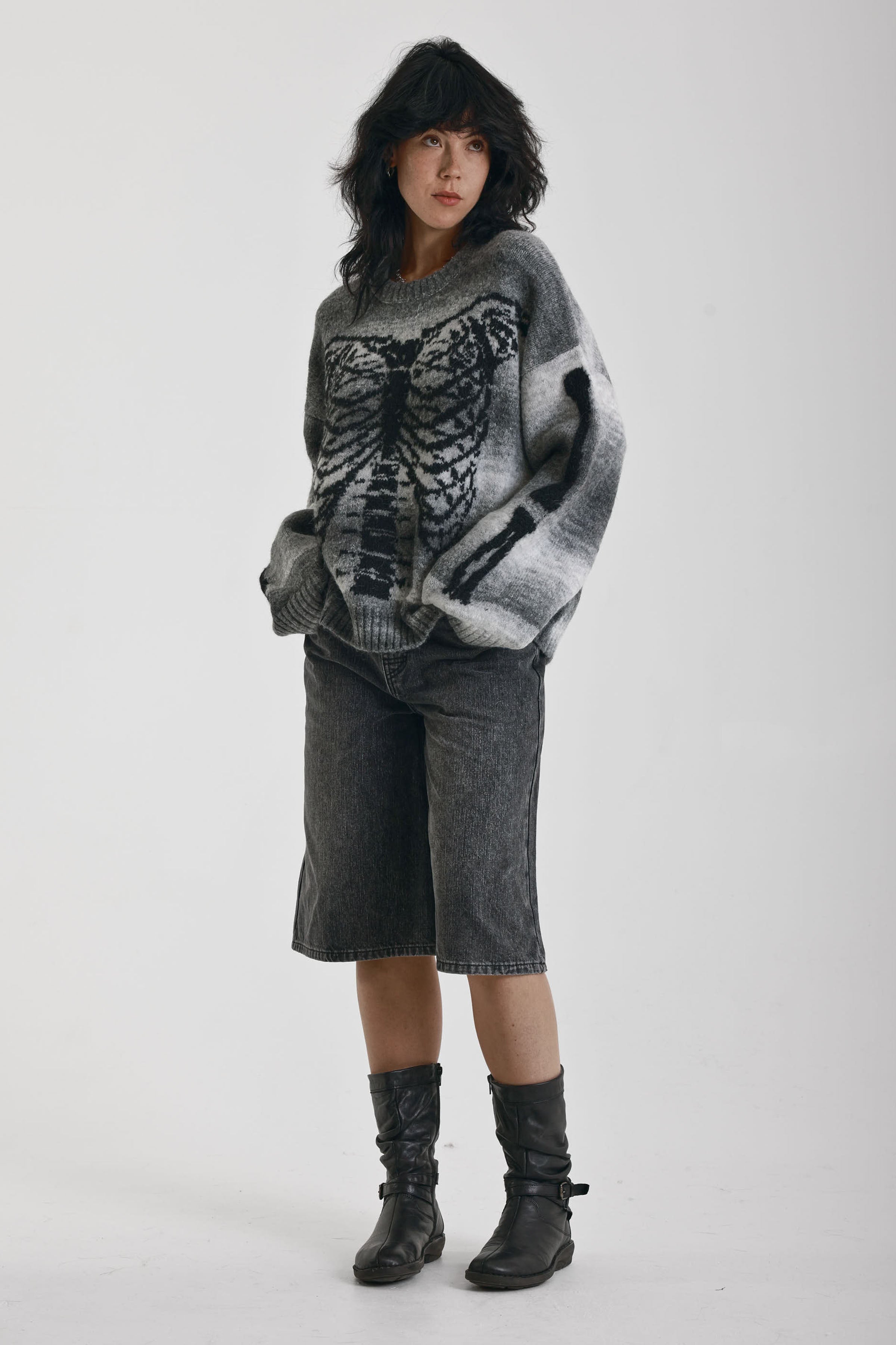 Grey spacedye stripe oversized knit jumper with skeleton ribcage graphic, worn by model