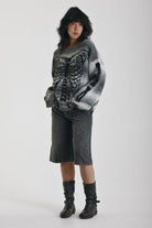 Grey spacedye stripe oversized knit jumper with skeleton ribcage graphic, worn by model