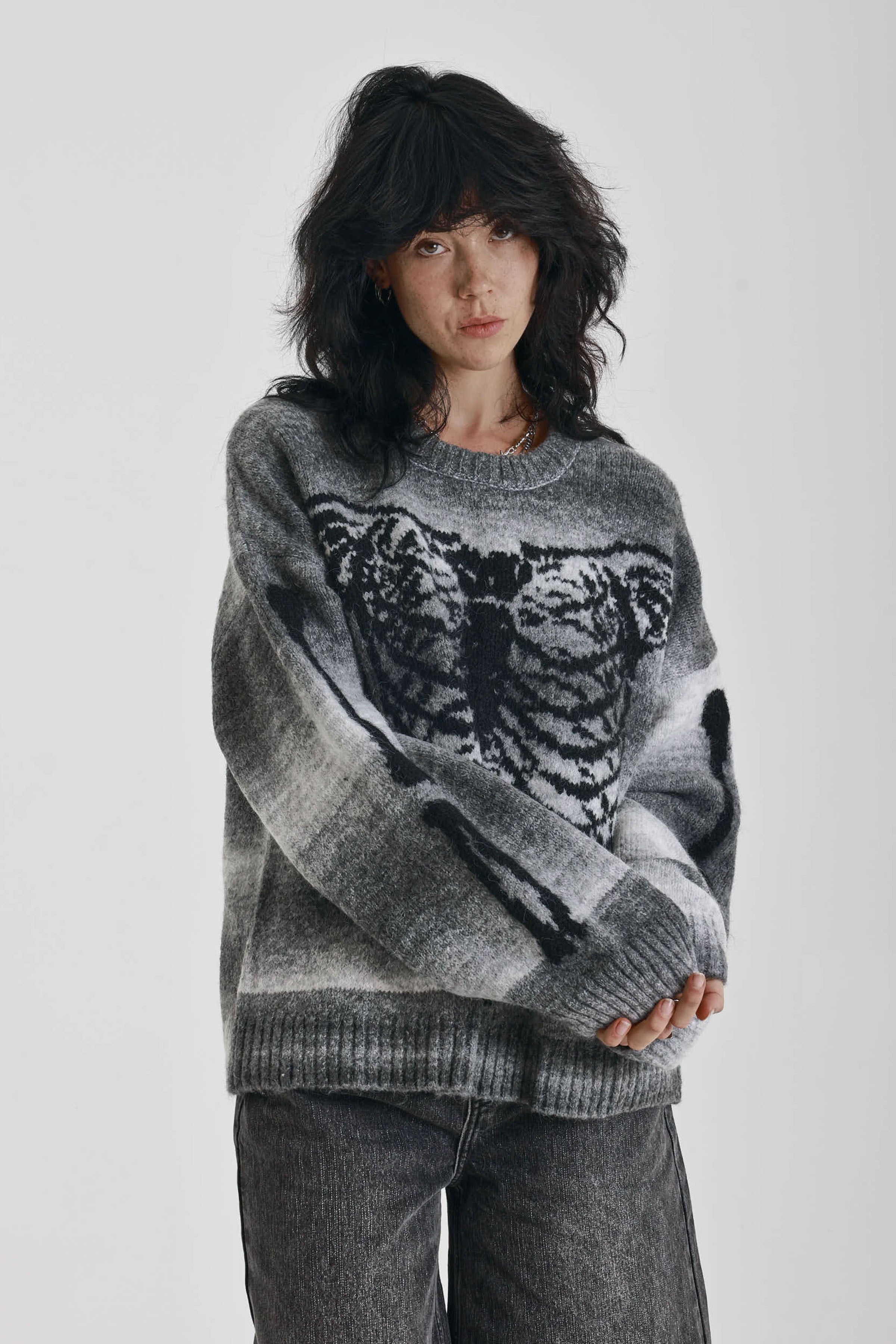 Grey spacedye stripe oversized knit jumper with skeleton ribcage graphic, worn by model