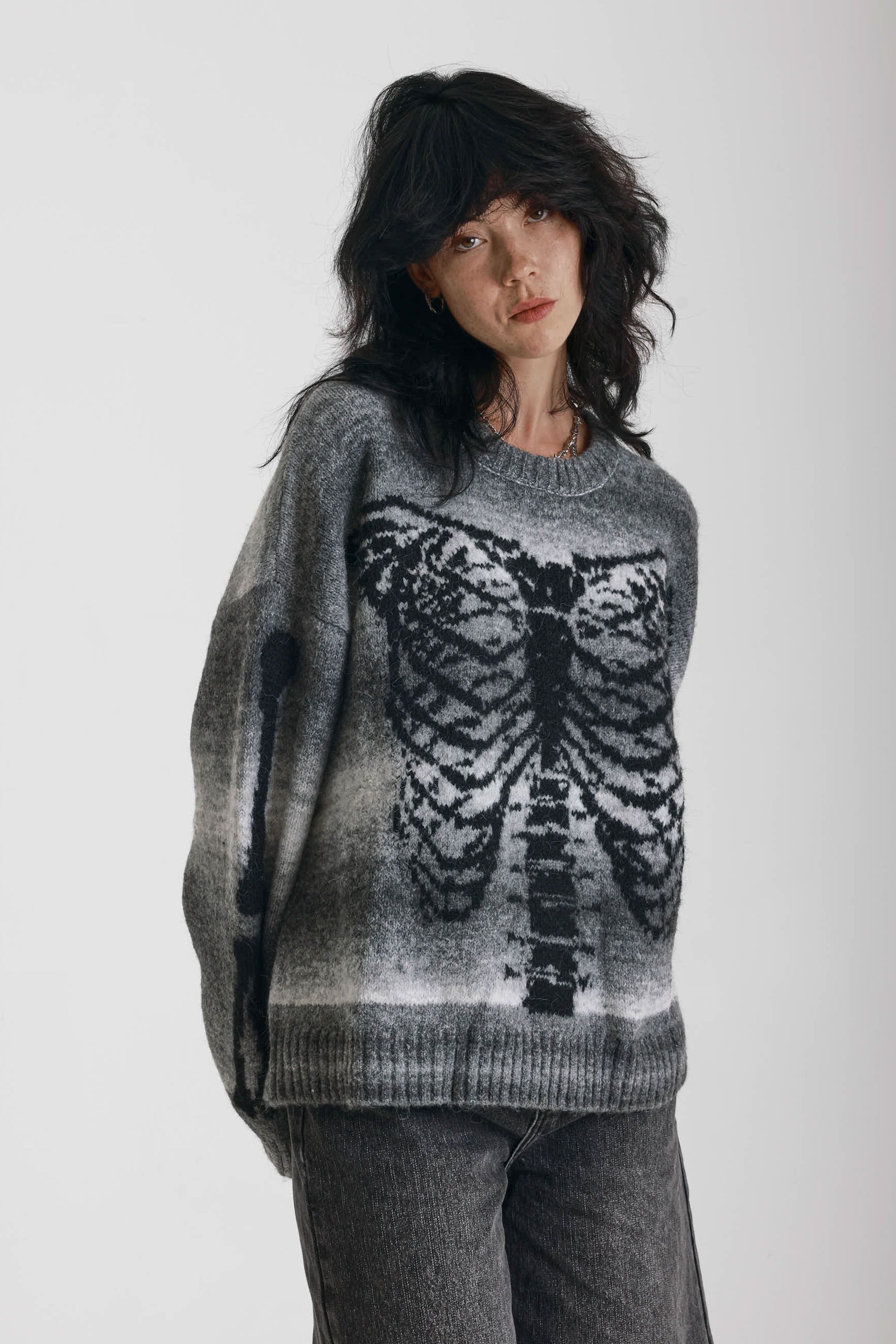 Grey spacedye stripe oversized knit jumper with skeleton ribcage graphic, worn by model
