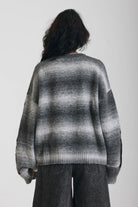 Grey spacedye stripe oversized knit jumper with skeleton ribcage graphic, worn by model