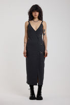 Charcoal plunging wrap dress with silver hardware clasps and D-ring strap detail, worn by model