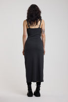 Back of charcoal plunging wrap dress with silver hardware clasps and D-ring strap detail, worn by model