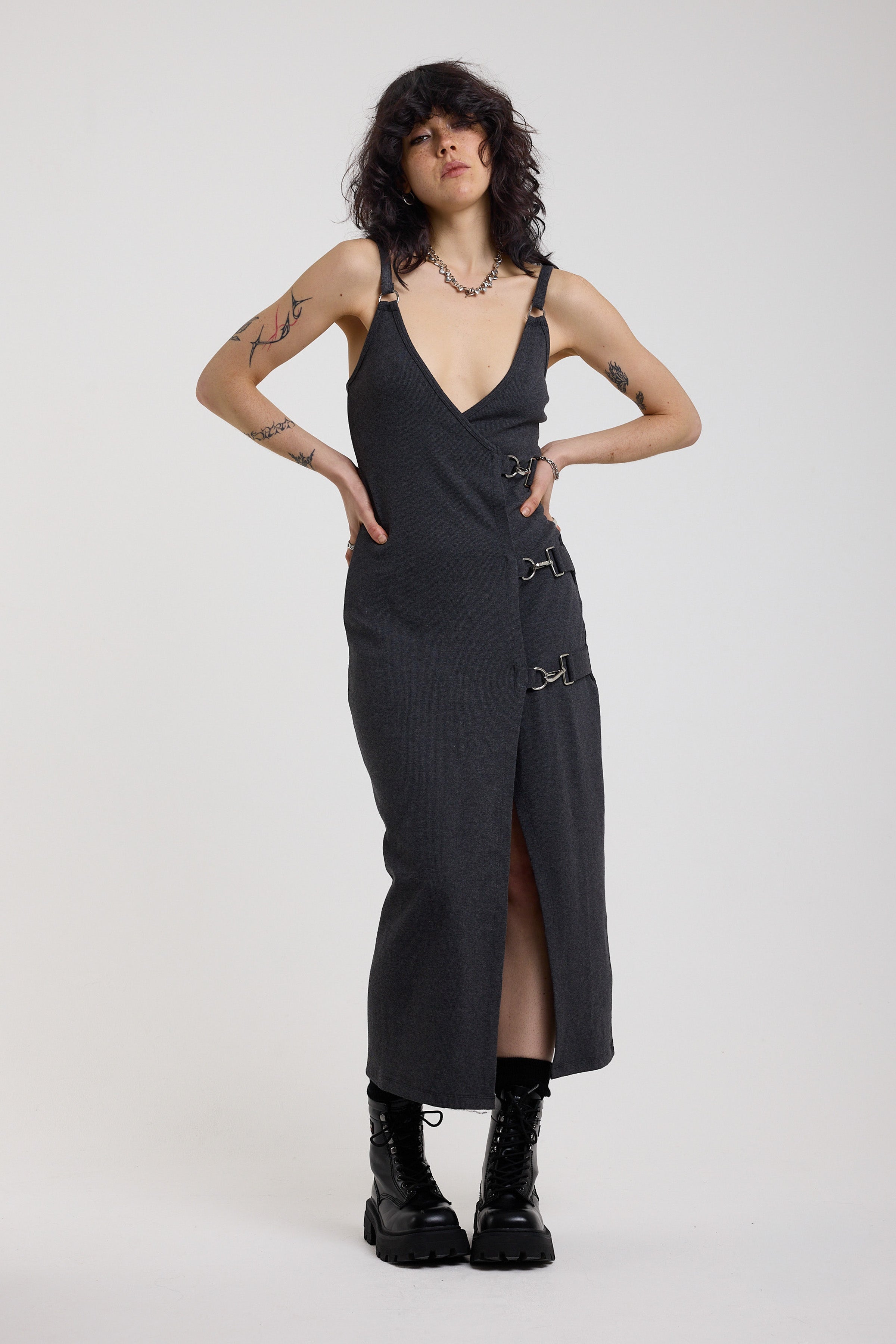 Charcoal plunging wrap dress with silver hardware clasps and D-ring strap detail, worn by model