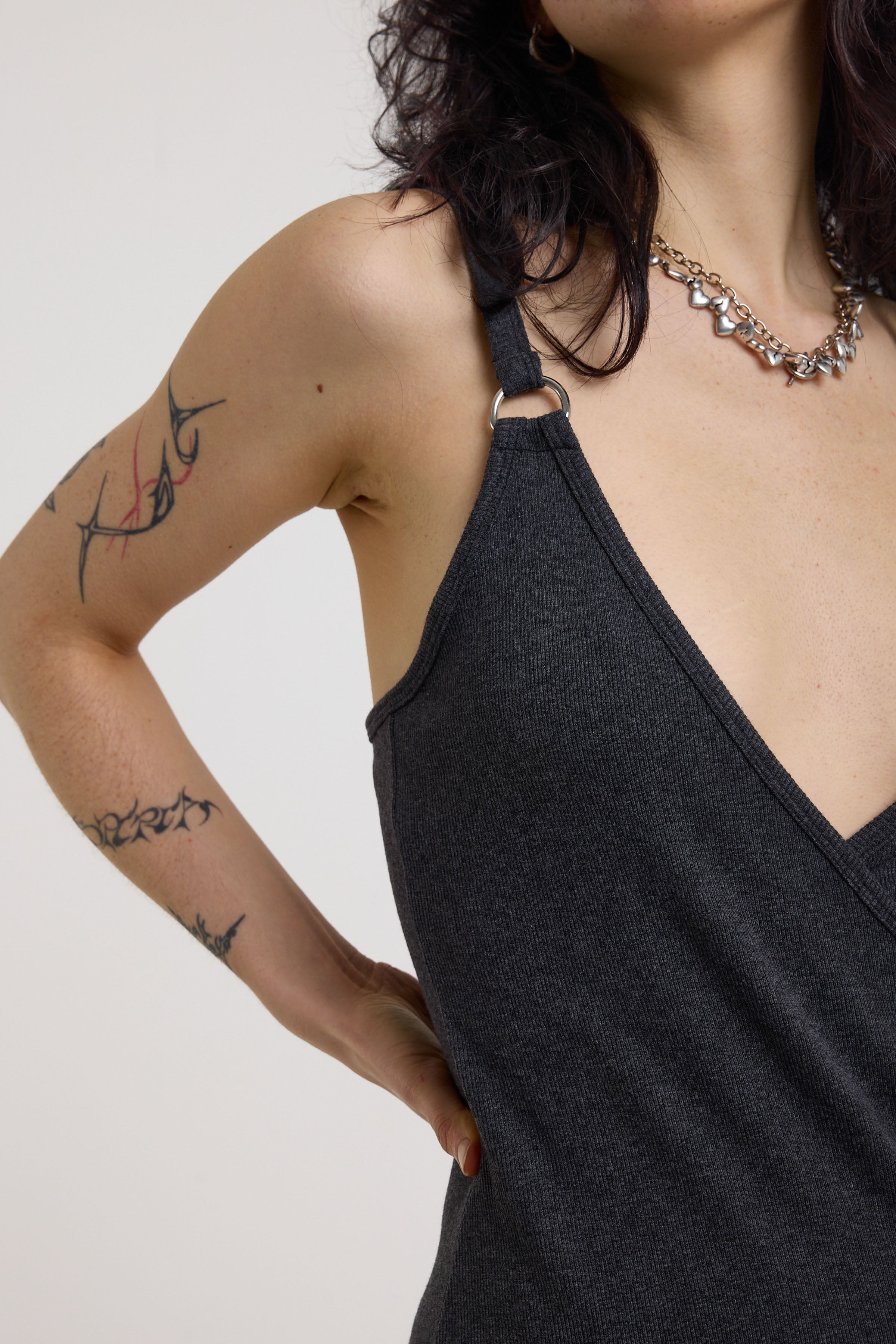 Silver D-ring strap detail and plunge neckline on charcoal wrap dress, worn by model
