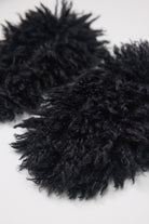 Black shaggy faux fur mittens.