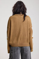Back of brown oversized knit jumper with skeleton graphic, worn by model