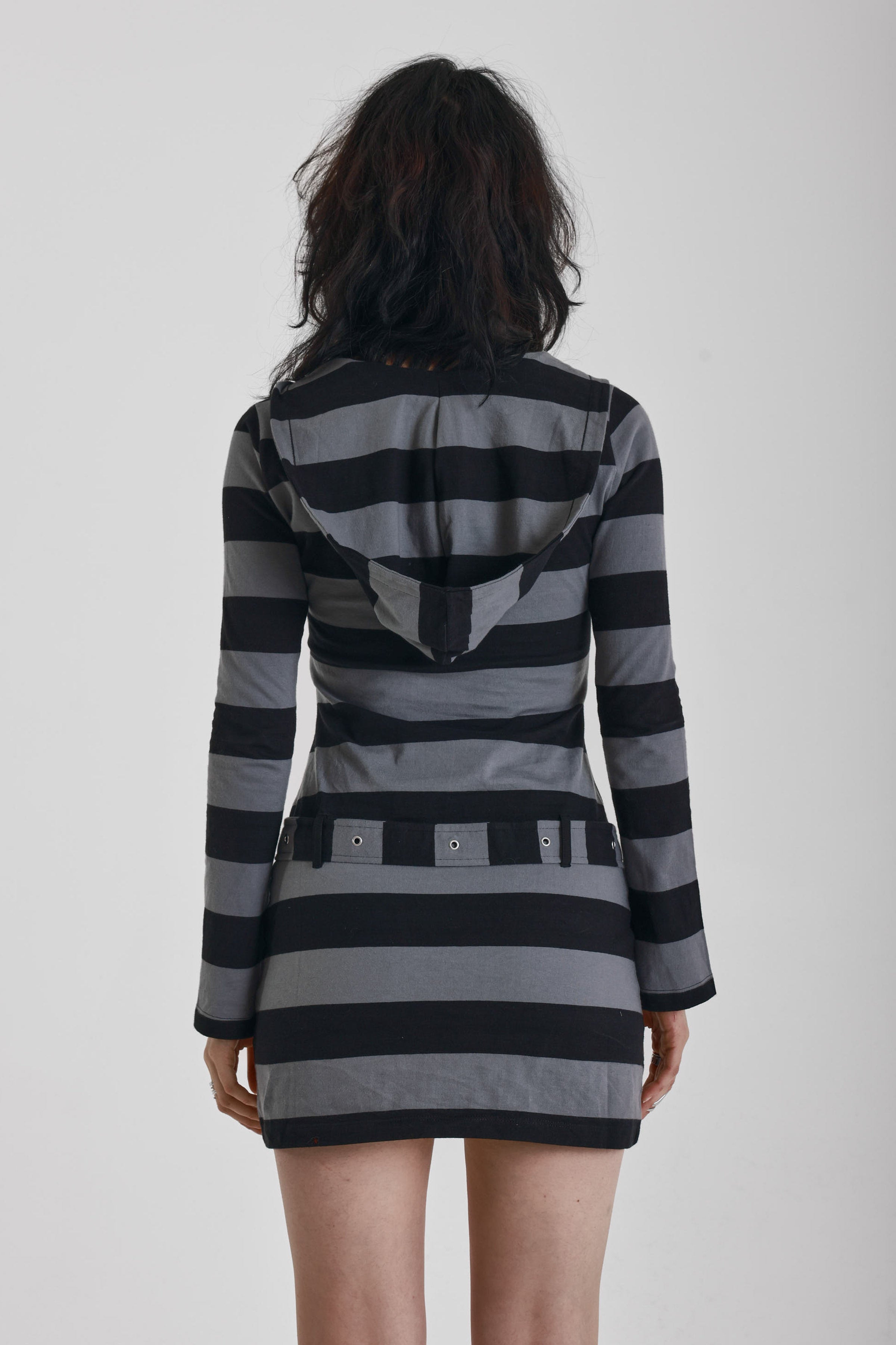 Black and grey stripe hooded mini dress with eyelet belt, worn by model