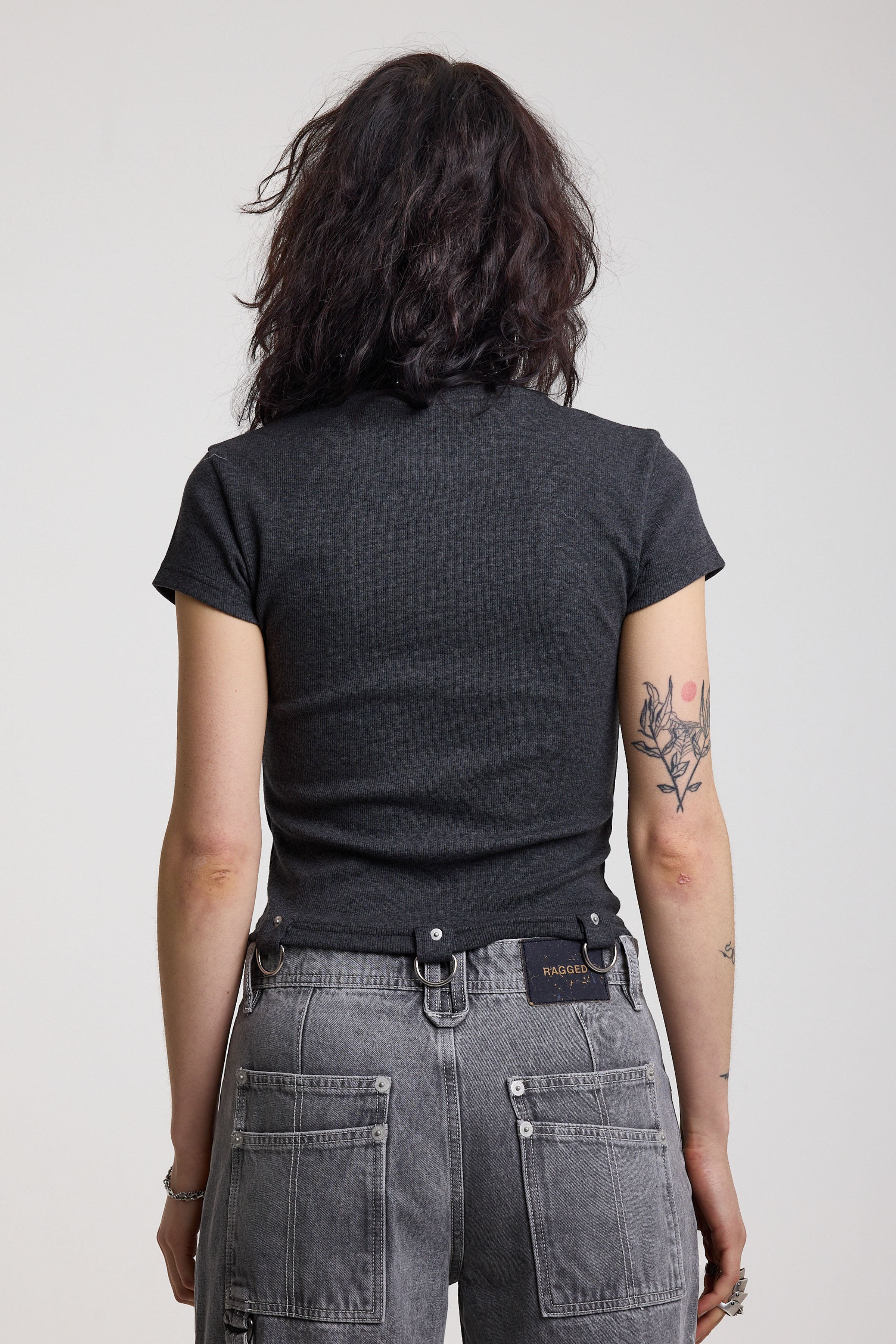 Back of charcoal ribbed crop t-shirt with silver D-ring hardware detail, worn by model