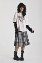 Ecru long sleeve skate t-shirt with screen printed grunge thorn heart print, worn by model
