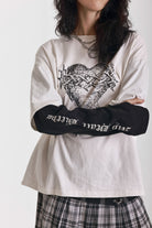 Ecru long sleeve skate t-shirt with screen printed grunge thorn heart print, worn by model