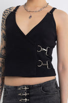 Black plunging wrap top with silver trigger clasps, worn by model