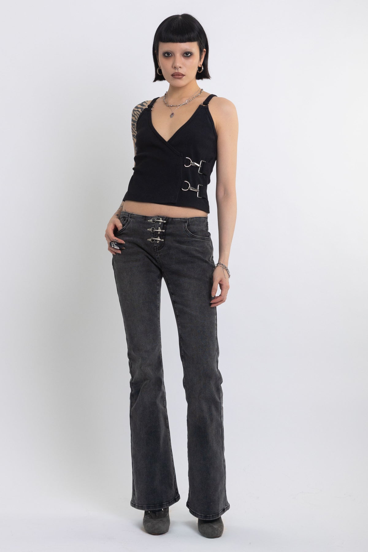 Black plunging wrap top with silver trigger clasps, worn by model