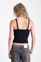 Black plunge wrap front top with silver trigger clasps and D-ring strap detail, worn by model