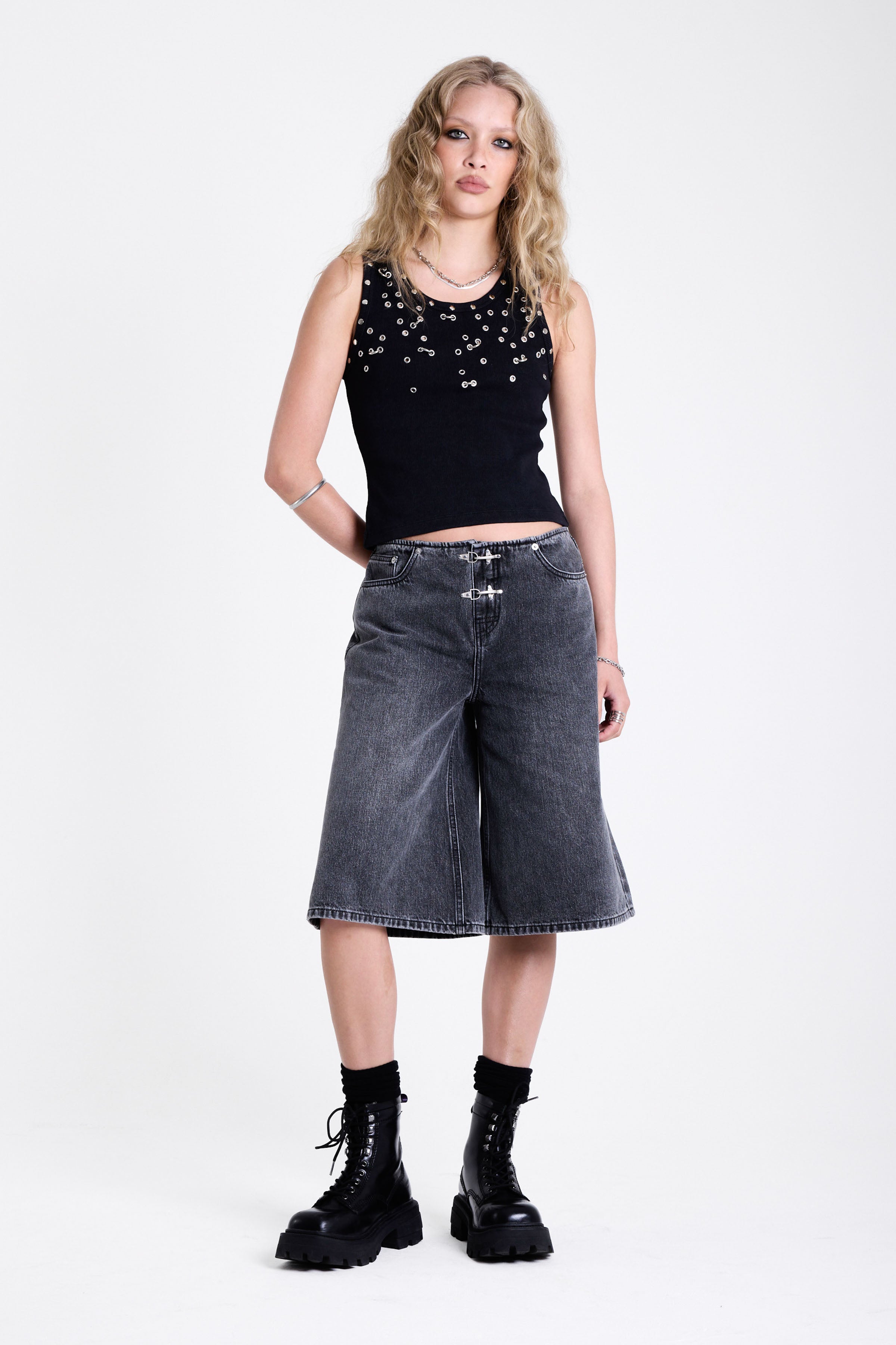 Washed black longline oversized denim jorts with no waistband and silver latch clasp detail, worn by model