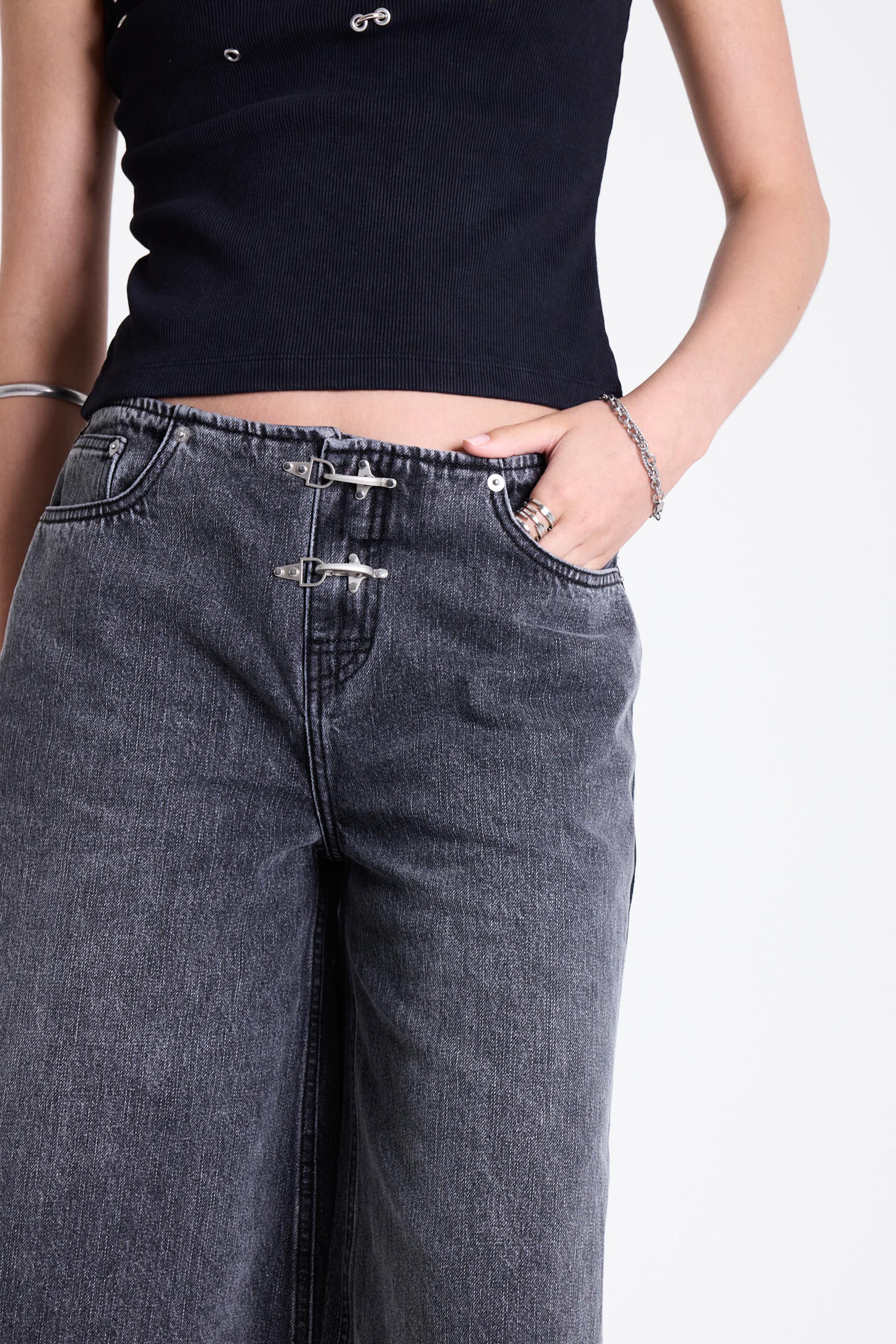 Washed black longline oversized denim jorts with no waistband and silver latch clasp detail, worn by model