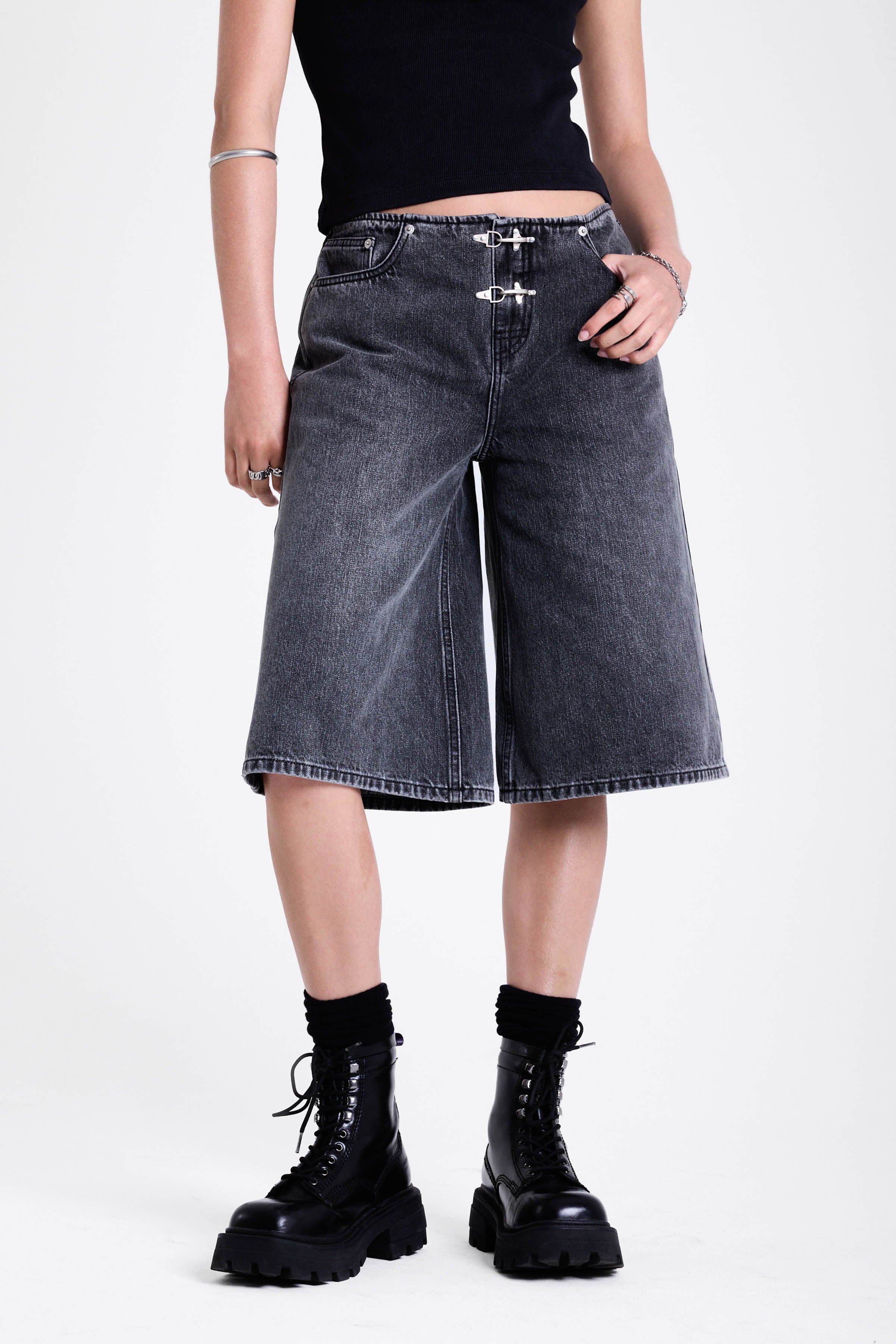 Washed black longline oversized denim jorts with no waistband and silver latch clasp detail, worn by model