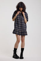 Navy check mini dress with button down and peplum hem, worn by model