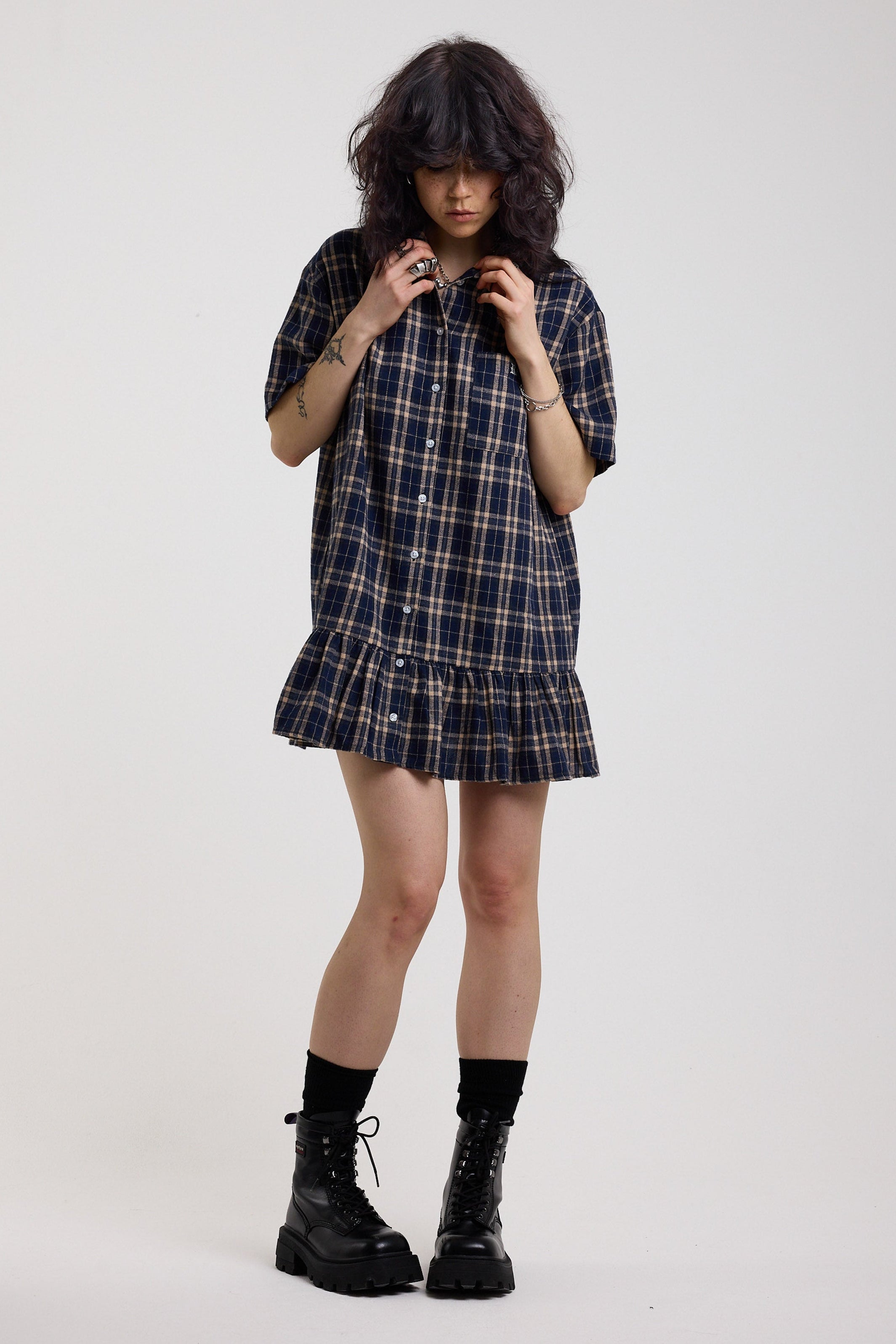 Navy check mini dress with button down and peplum hem, worn by model