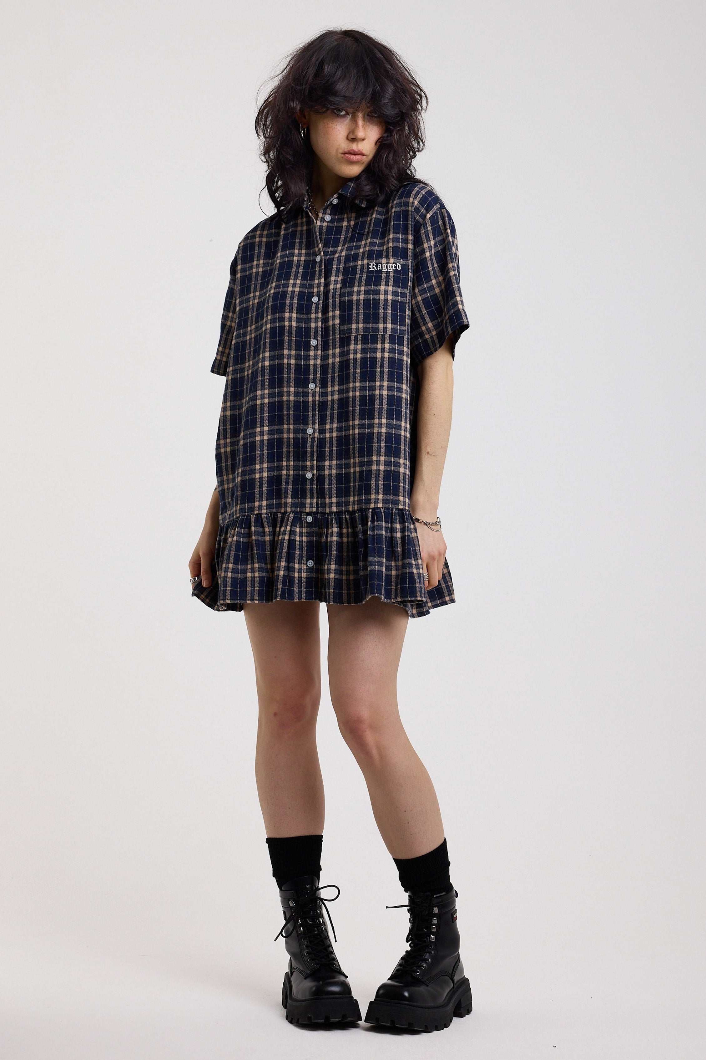 Navy and yellow check shirt style mini dress with buttons, collar and peplum hem, worn by model