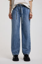 Blue baggy balloon boyfriend jeans with denim tie belt, worn by model
