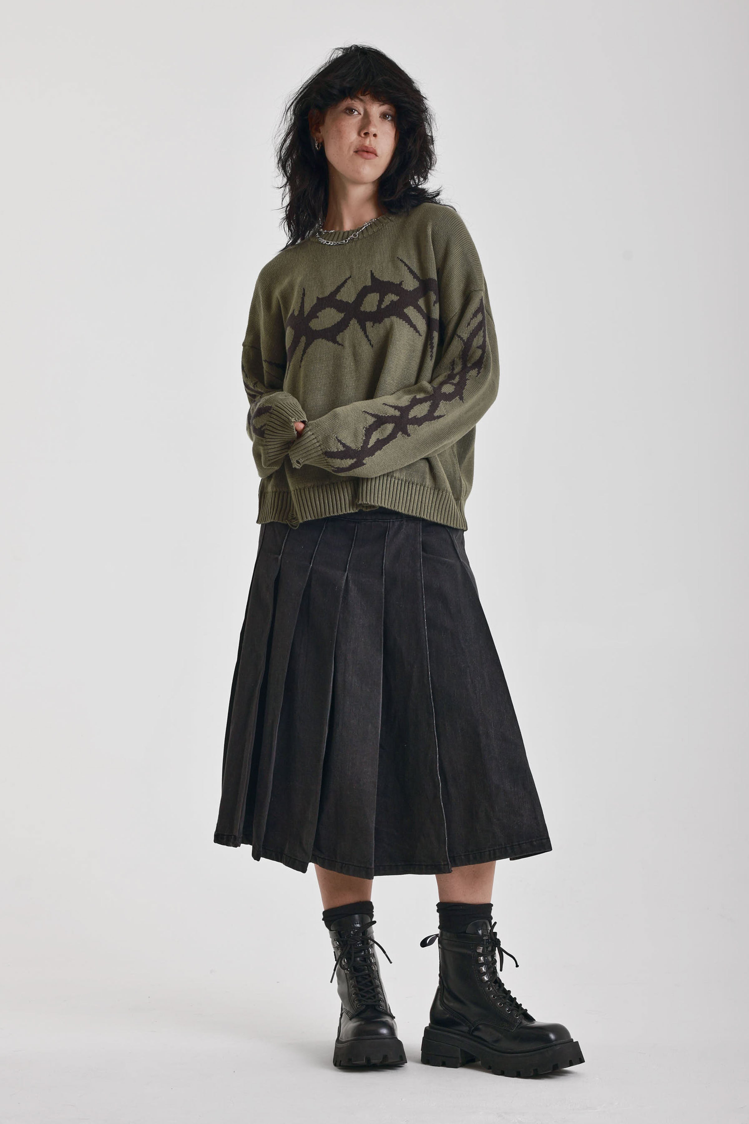 Washed khaki oversized knit jumper with black barbed wire tattoo graphic, worn by model