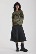 Washed khaki oversized knit jumper with black barbed wire tattoo graphic, worn by model