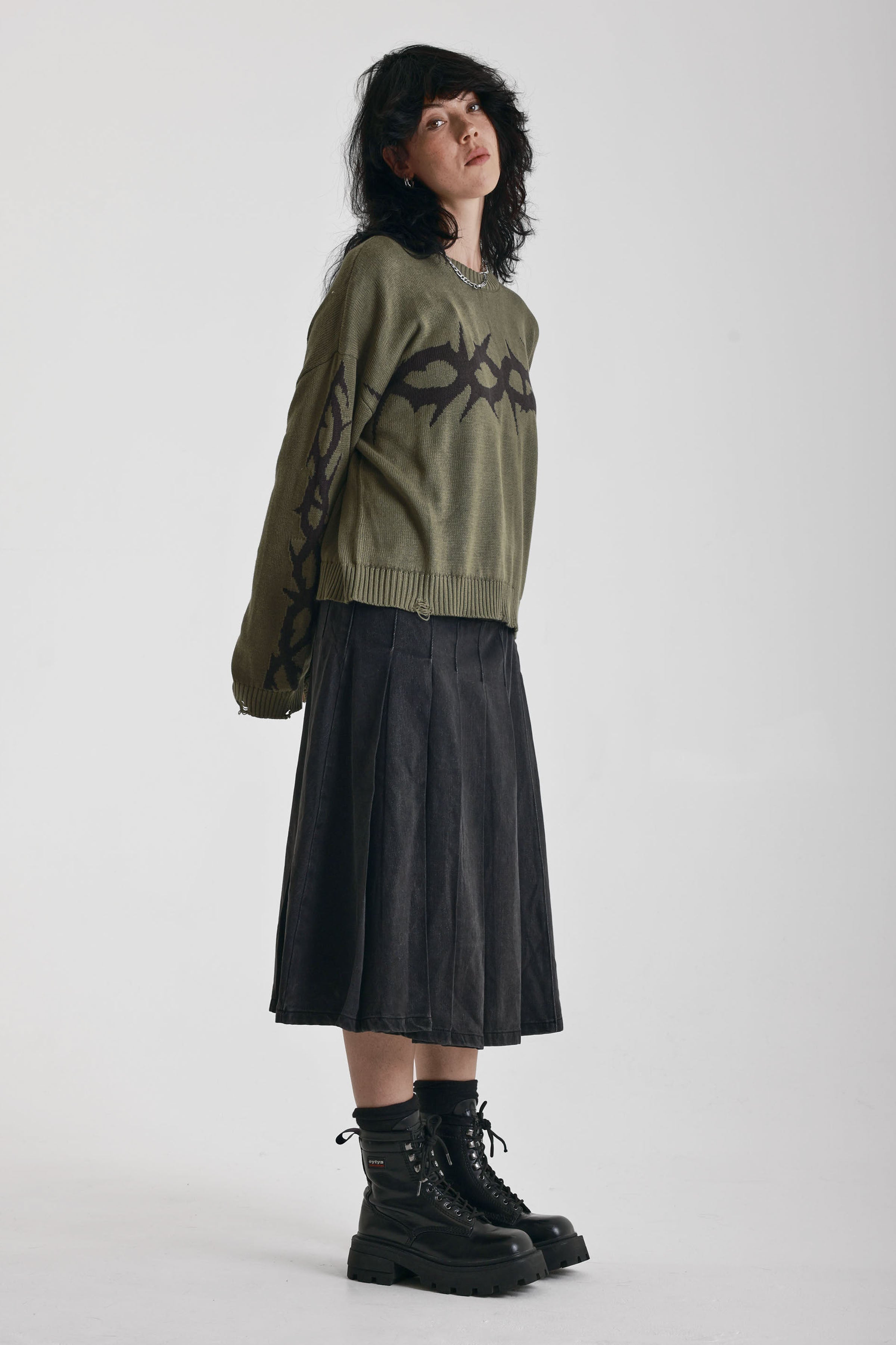 Washed khaki oversized knit jumper with black barbed wire tattoo graphic, worn by model