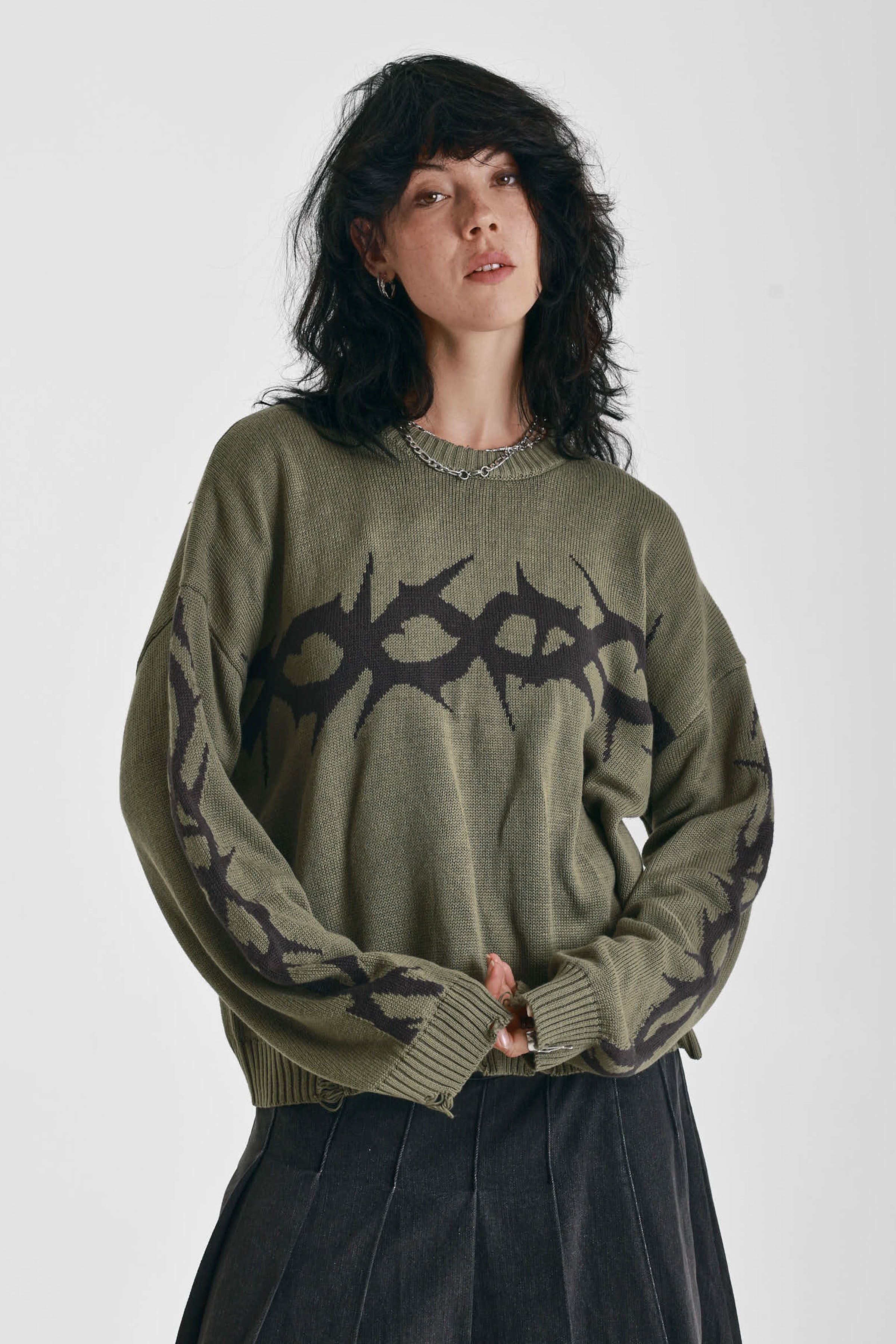 Washed khaki oversized knit jumper with black barbed wire tattoo graphic, worn by model
