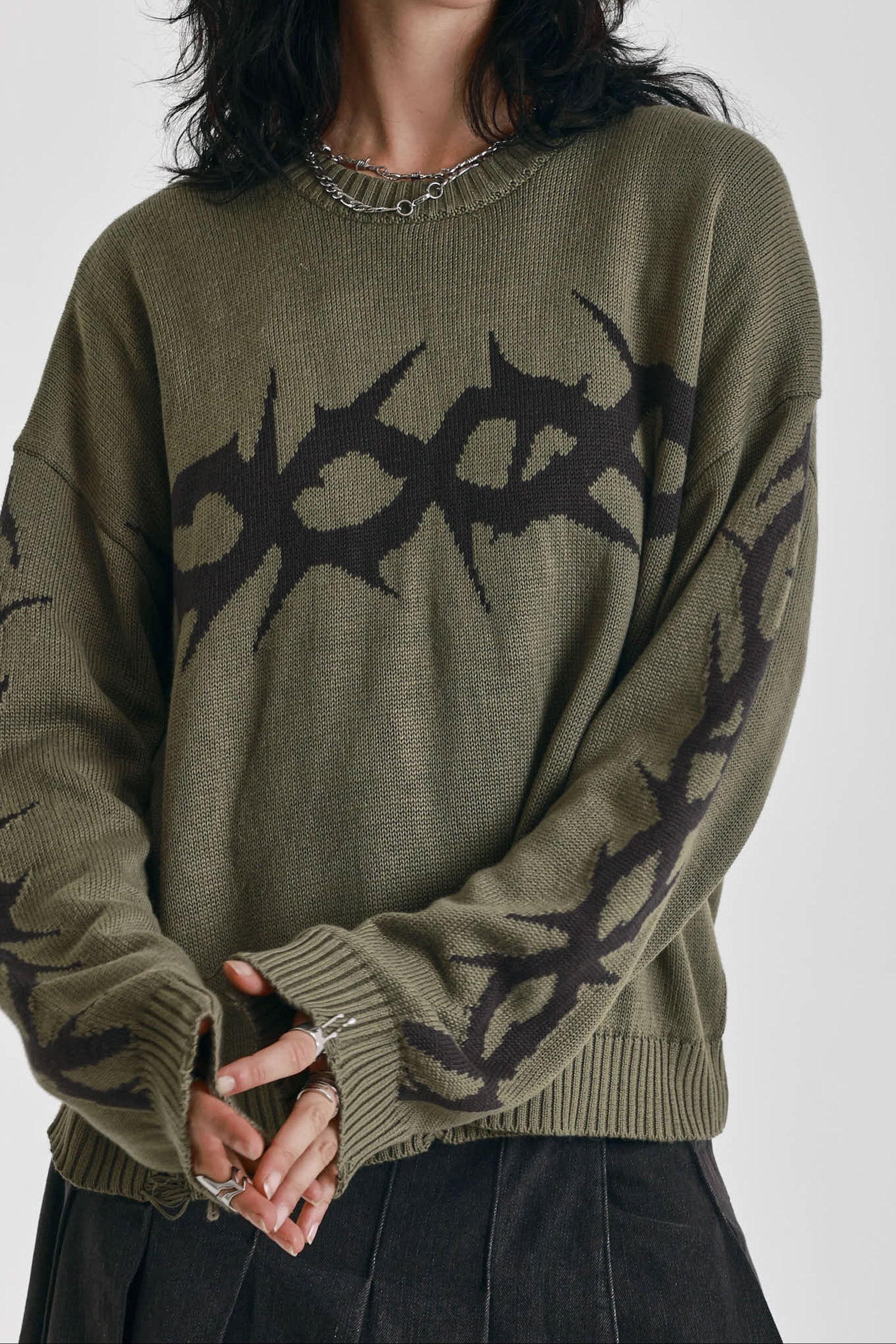 Washed khaki oversized knit jumper with black barbed wire tattoo graphic, worn by model