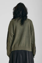 Washed khaki oversized knit jumper with black barbed wire tattoo graphic, worn by model