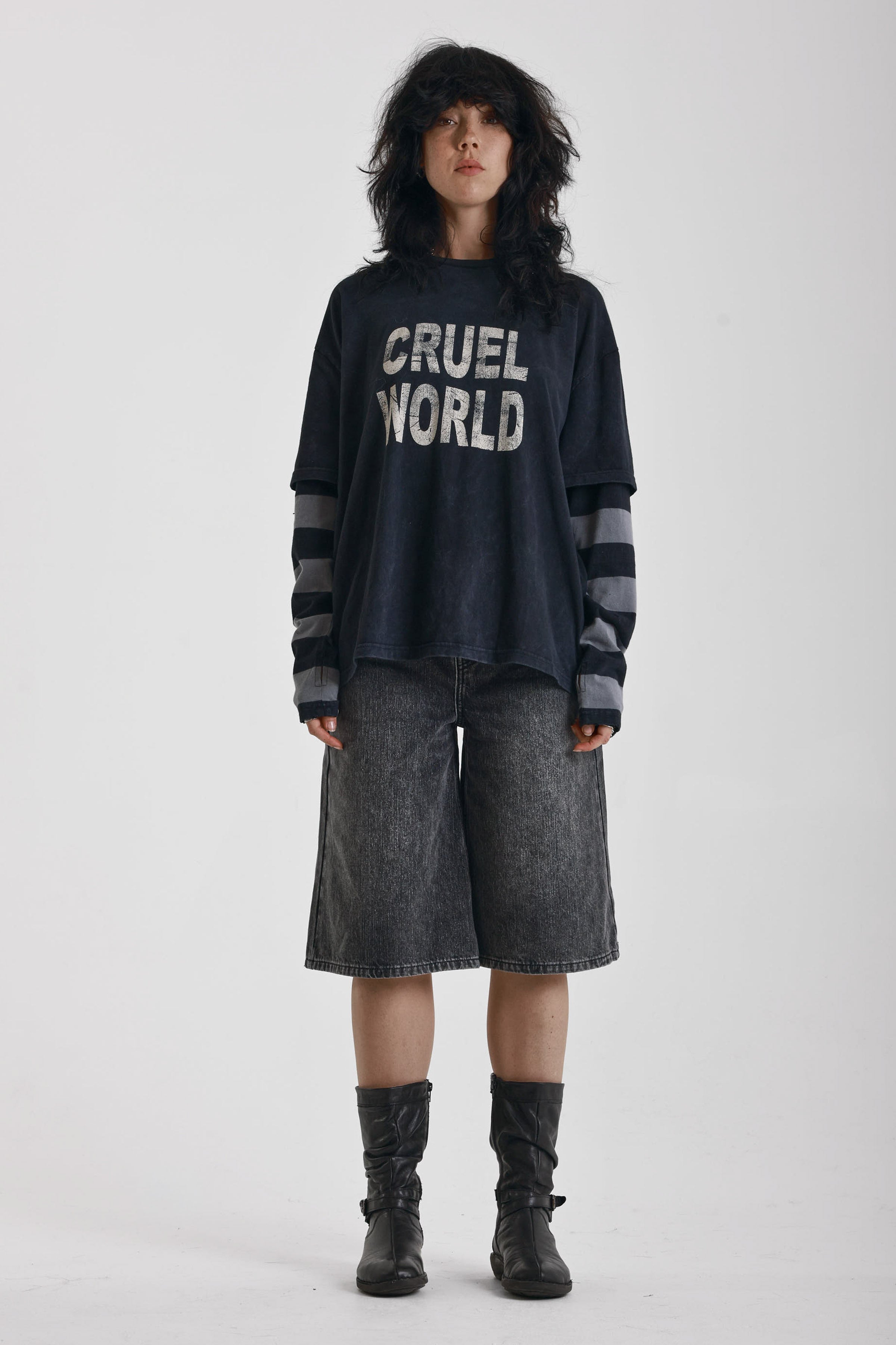 Washed black long sleeve skate t-shirt with CRUEL WORLD graphic print and contrast stripe sleeves, worn by model
