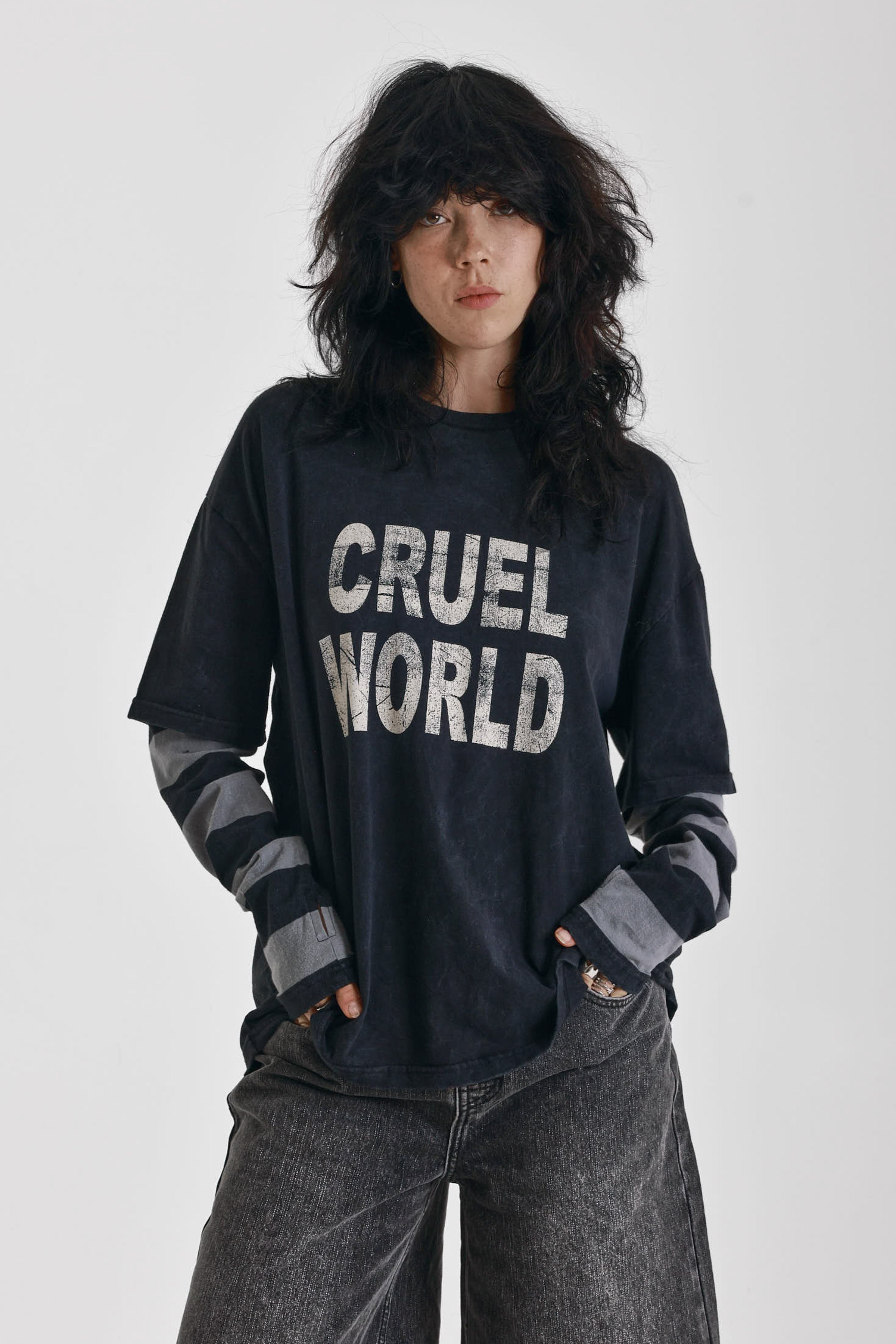 Washed black long sleeve skate t-shirt with CRUEL WORLD graphic print and contrast stripe sleeves, worn by model