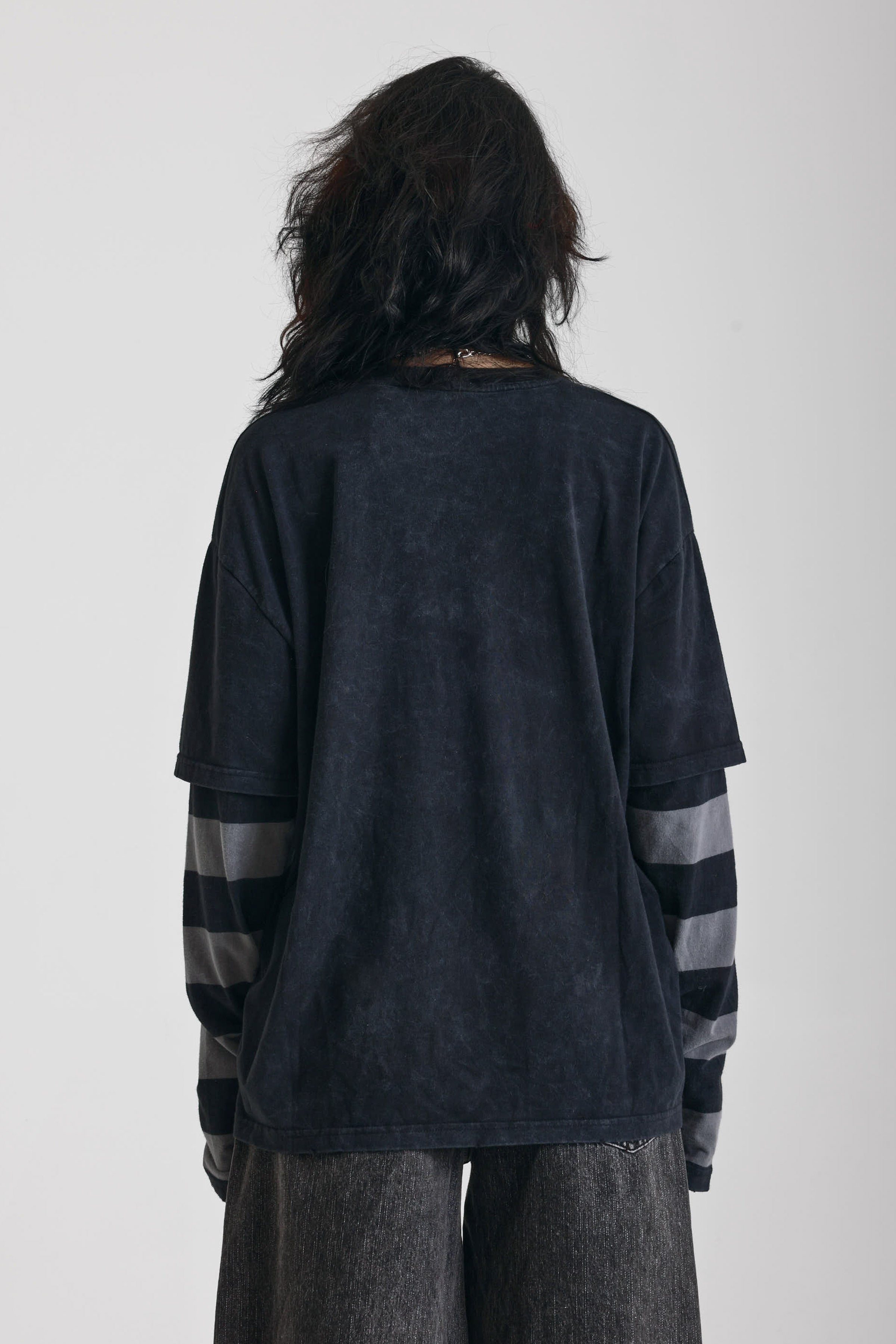 Washed black long sleeve skate t-shirt with CRUEL WORLD graphic print and contrast stripe sleeves, worn by model