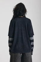 Washed black long sleeve skate t-shirt with CRUEL WORLD graphic print and contrast stripe sleeves, worn by model