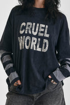 Washed black long sleeve skate t-shirt with CRUEL WORLD graphic print and contrast stripe sleeves, worn by model