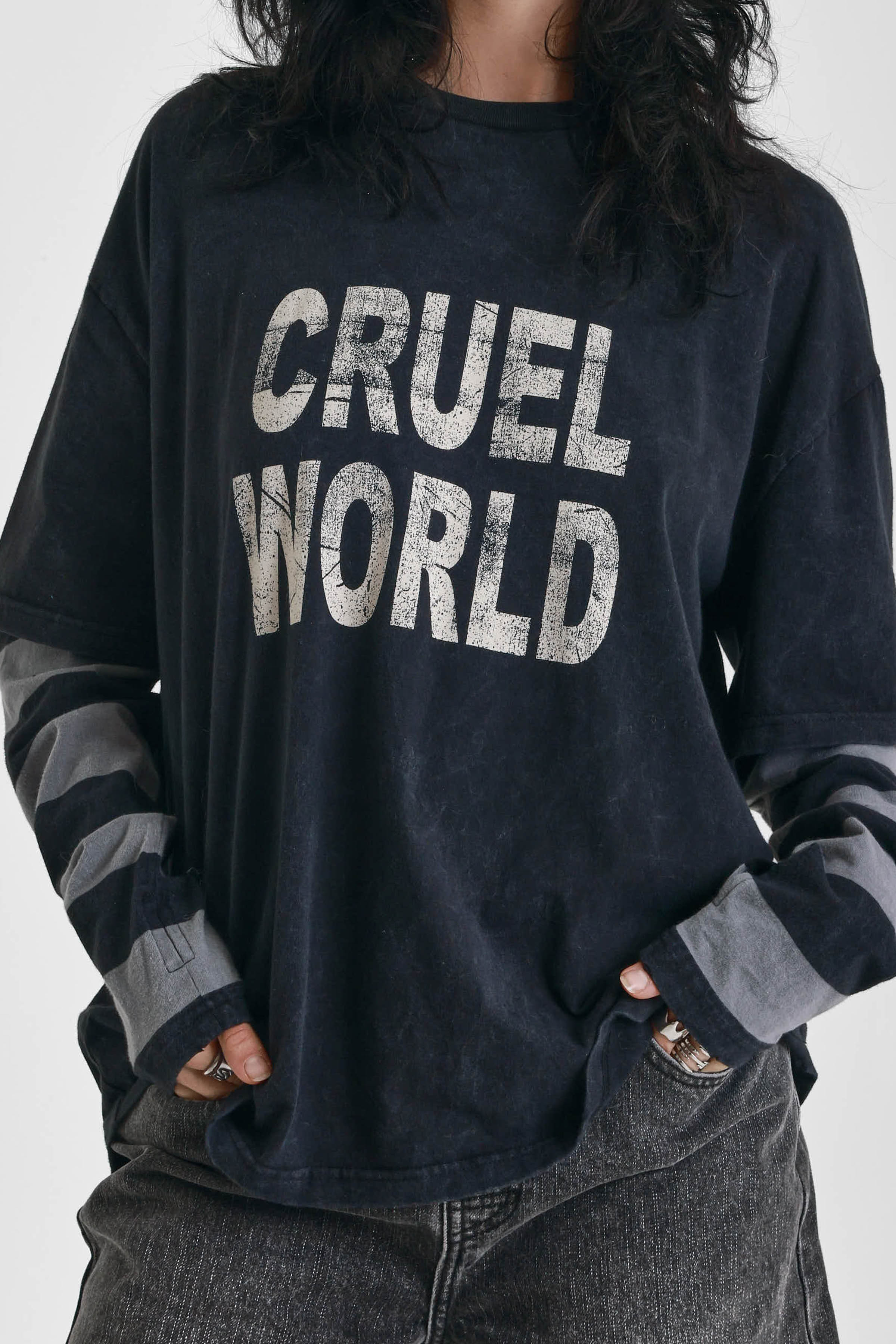 Washed black long sleeve skate t-shirt with CRUEL WORLD graphic print and contrast stripe sleeves, worn by model