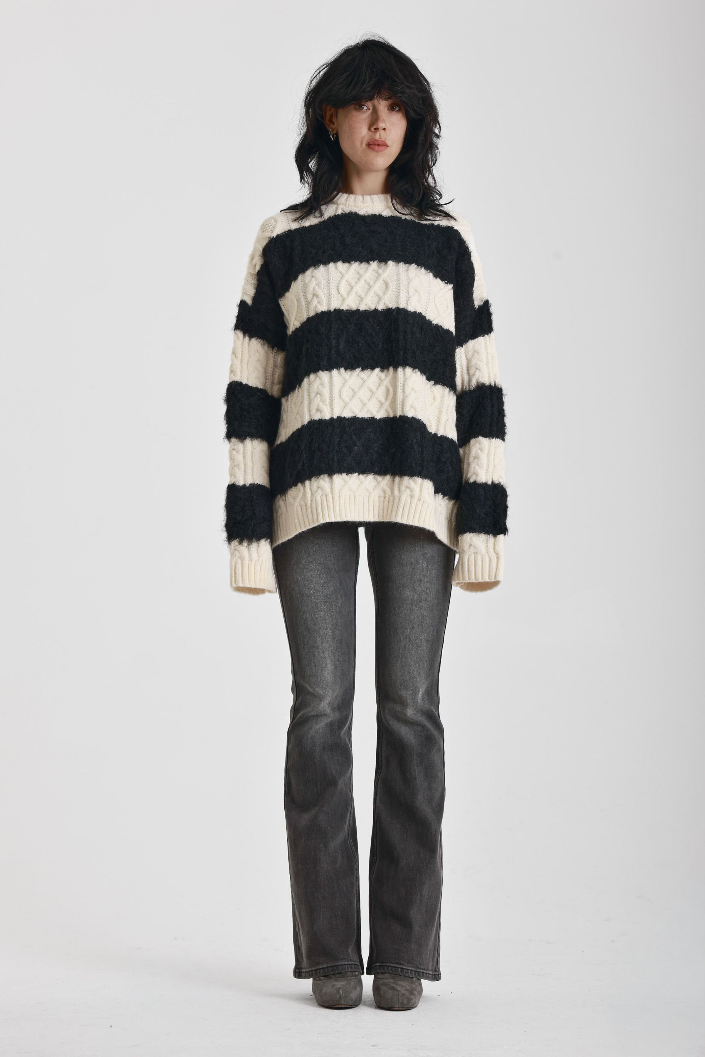 Black and white stripe textured cable knit oversized jumper, worn by model