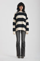 Black and white stripe textured cable knit oversized jumper, worn by model