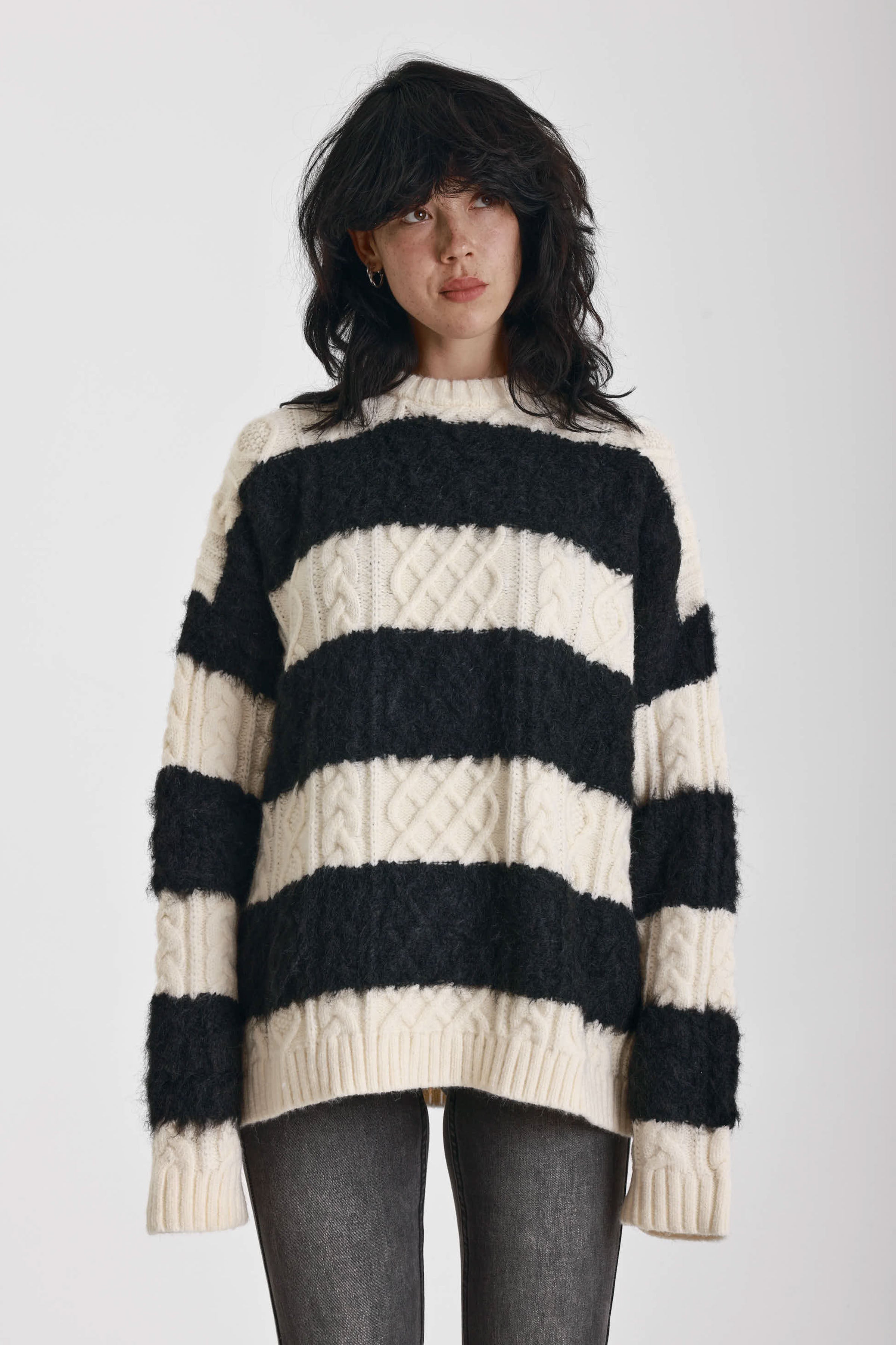 Black and white stripe textured cable knit oversized jumper, worn by model