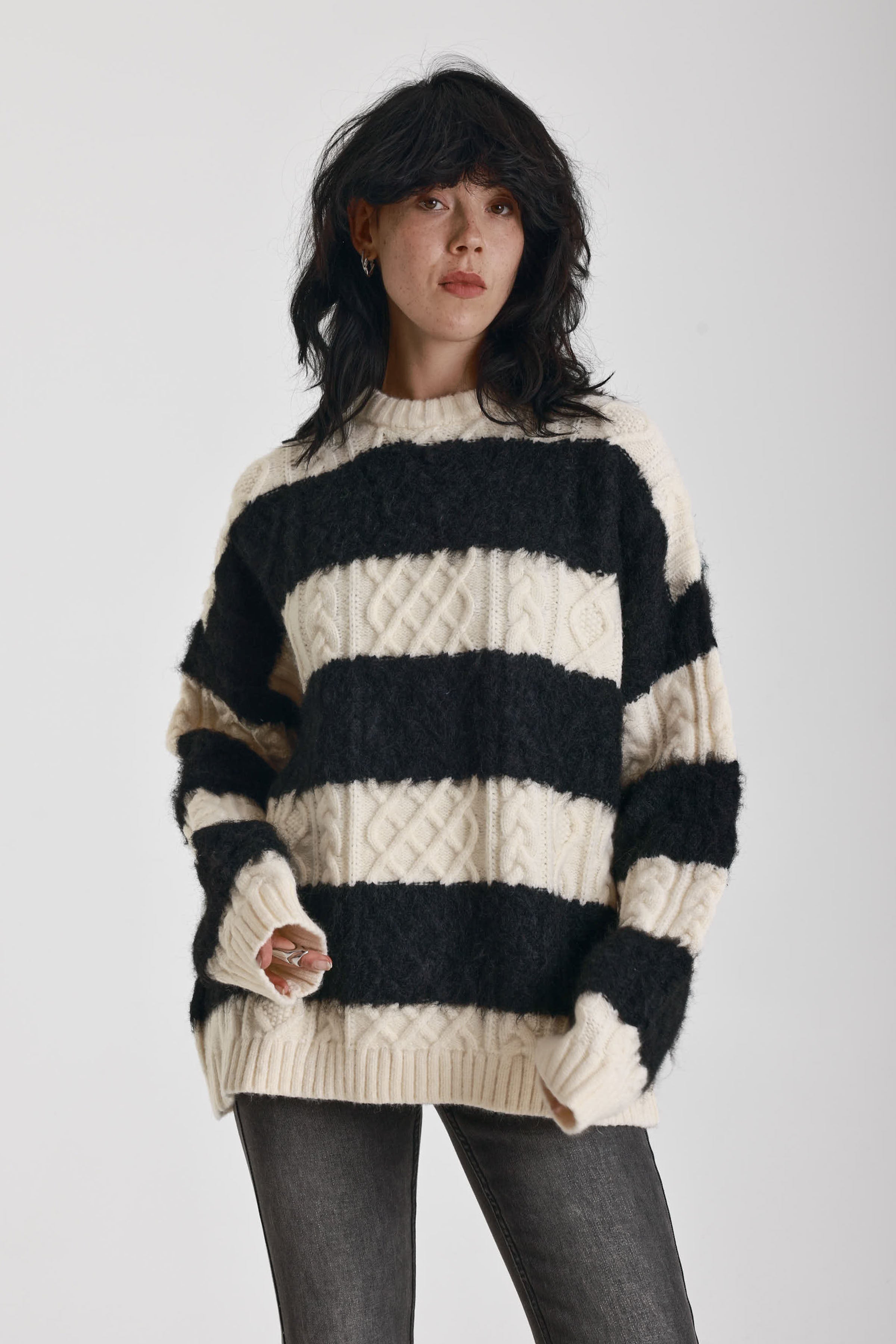 Black and white stripe textured cable knit oversized jumper, worn by model
