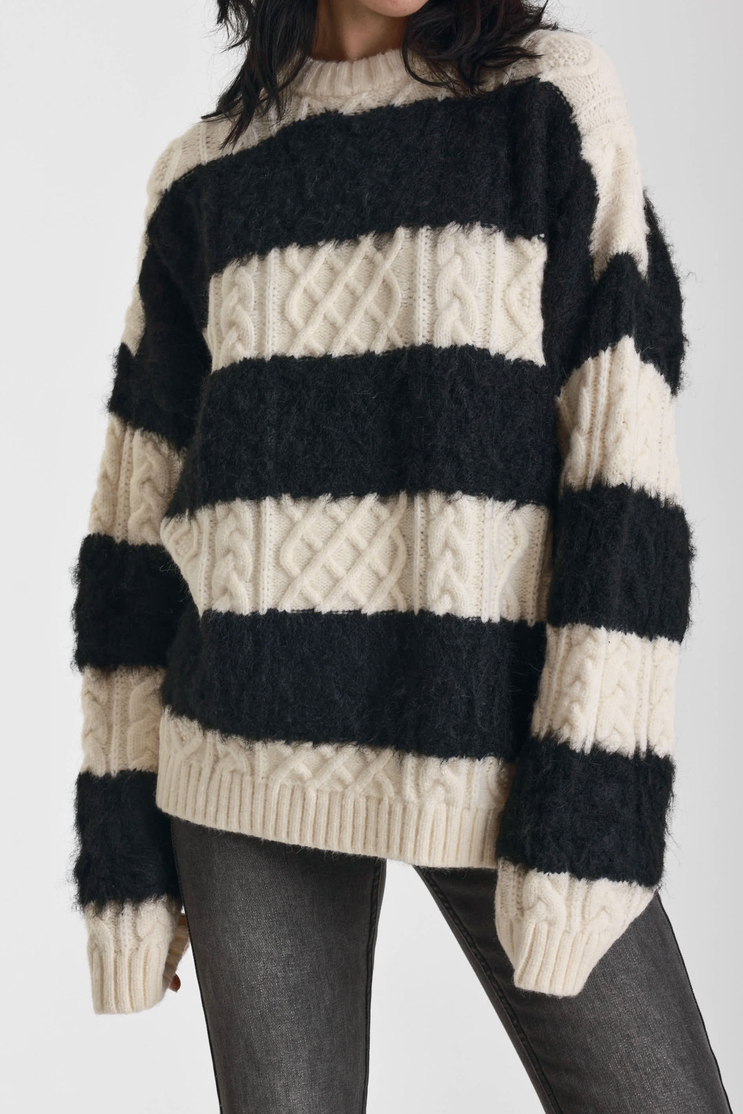 Black and white stripe textured cable knit oversized jumper, worn by model