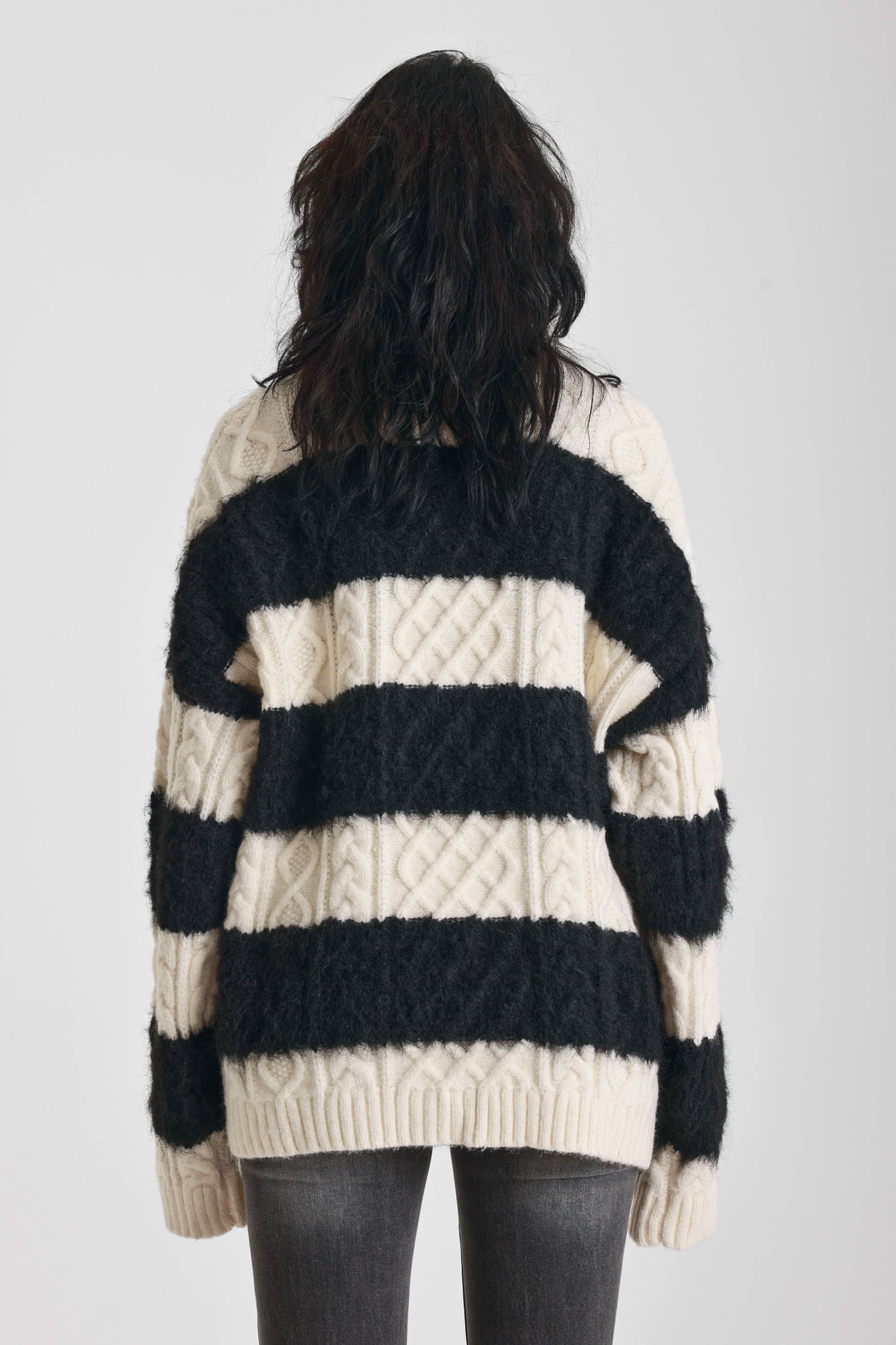 Black and white stripe textured cable knit oversized jumper, worn by model