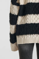 Black and white stripe textured cable knit oversized jumper, worn by model