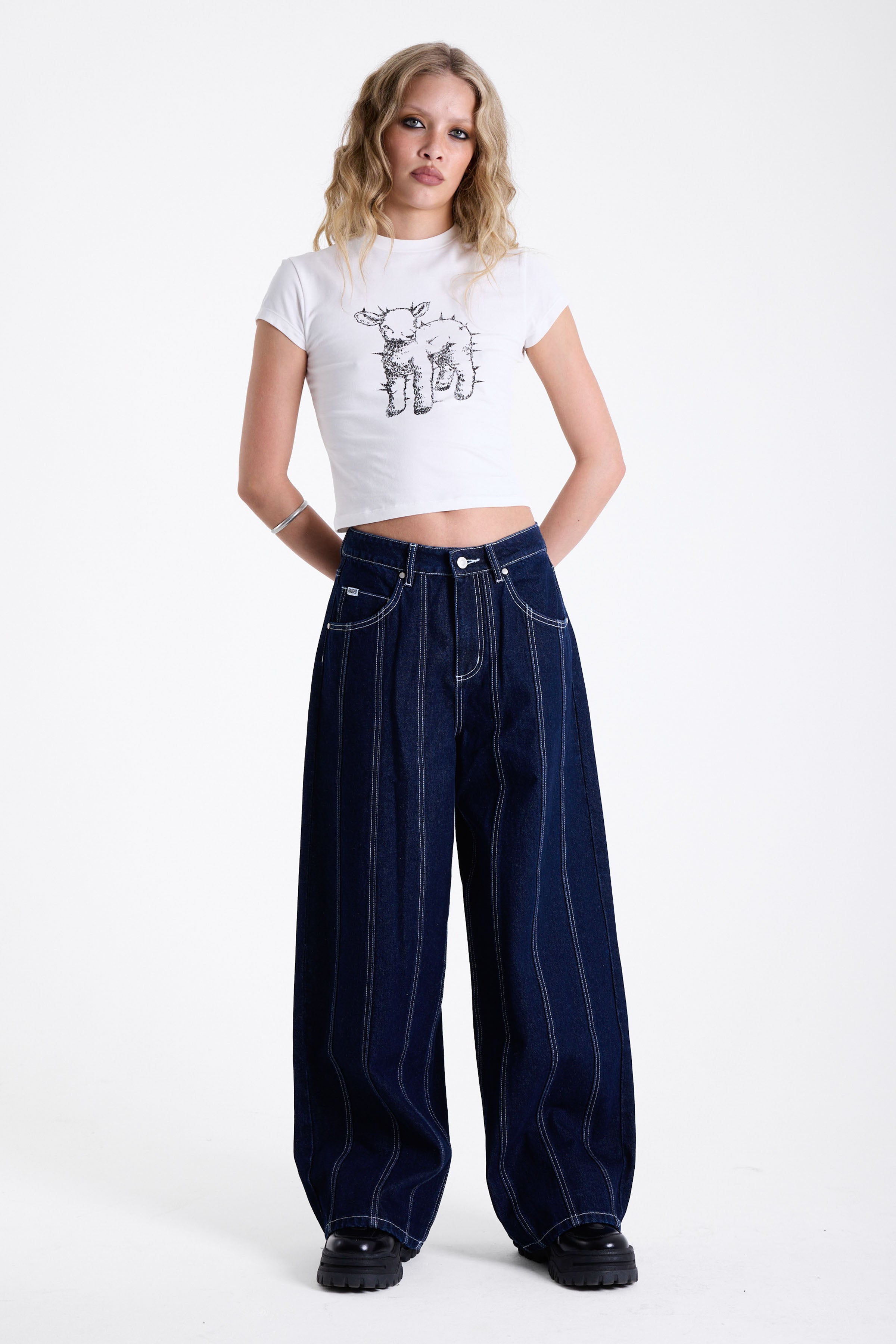 Dark rinse denim baggy wide leg jeans with contrast seam detail, worn by model.
