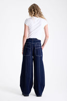Dark rinse denim baggy wide leg jeans with contrast seam detail, worn by model.