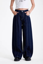Dark rinse denim baggy wide leg jeans with contrast seam detail, worn by model.