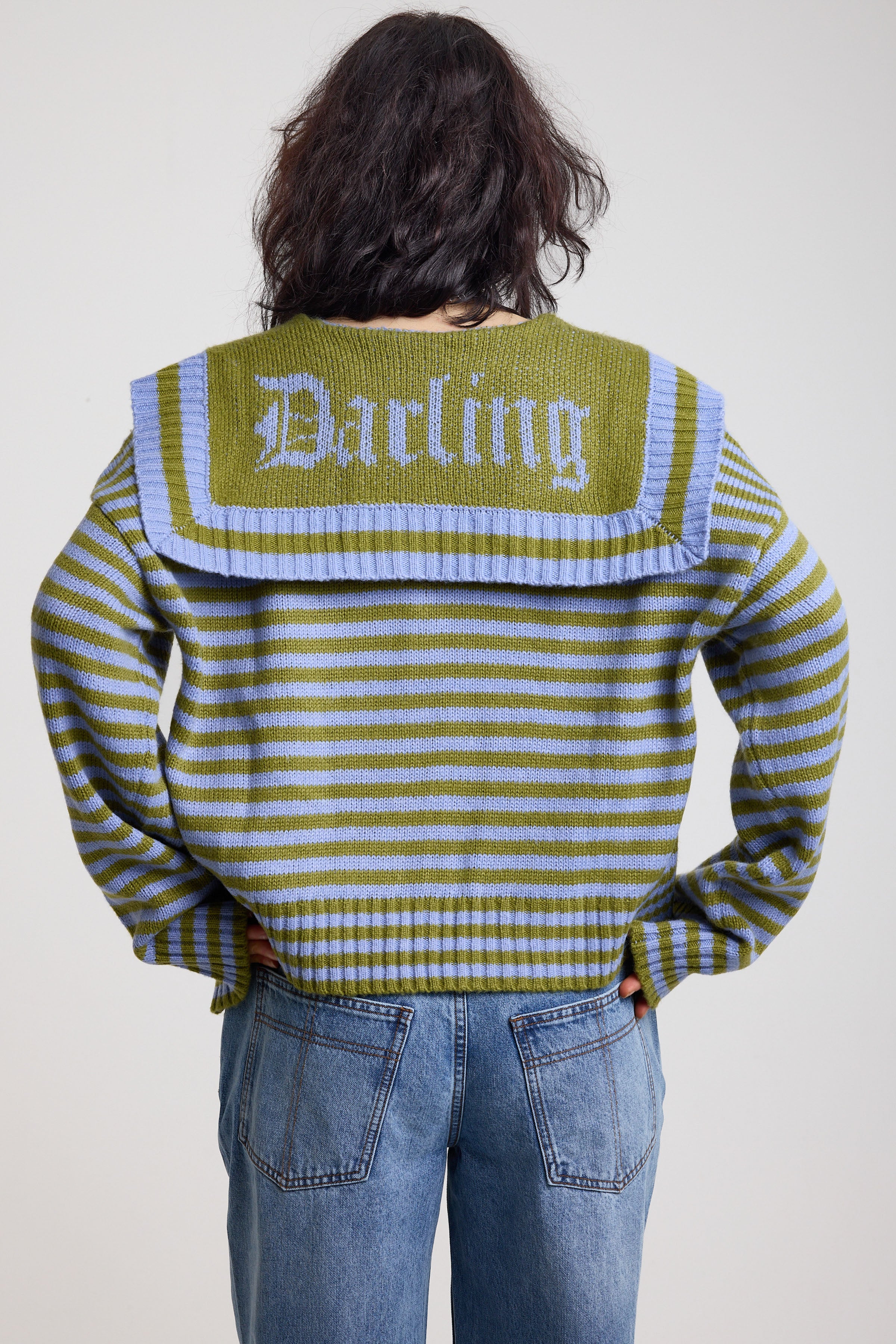 Back image of blue and green stripe knit cardigan with oversized collar with darling motif, worn by a model